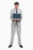 Businessman looking at the laptop he is presenting