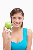 Young woman holding a green apple in her right hand