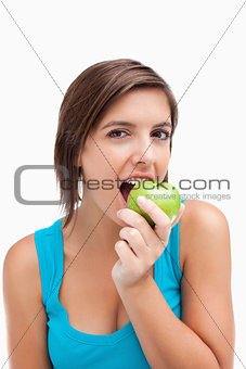 Attractive teenager eating a green apple