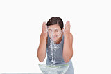 Young woman washing her face with a splash of water