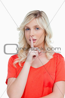 Beautiful fair-haired woman making a hand sign as an indication 