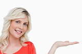 Smiling woman putting her hand palm up