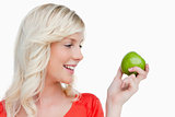 Young blonde woman looking on the side while holding a green app