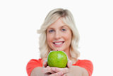 Green apple held by an attractive woman crossing her hands