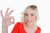 Young blonde woman showing the OK sign in front of the camera