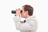 Side view of businessman using spy glasses