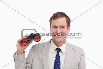 Smiling businessman with spy glasses