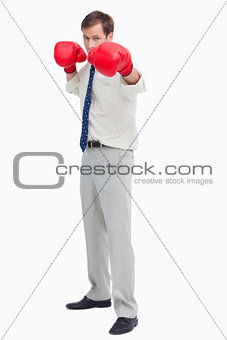Businessman with boxing gloves in offensive position