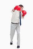Businessman attacking with boxing gloves
