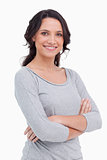 Close up of smiling young woman with her arms folded