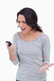 Close up of woman yelling into her mobile phone