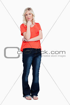 Serious teenager wearing casual clothes and standing with her fi