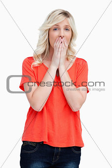 Teenager looking sad with her hands on her mouth