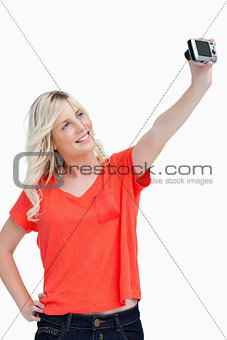 Smiling teenager posing in front of her digital camera
