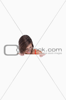 Teenage girl leaning her head forward while looking at a blank p