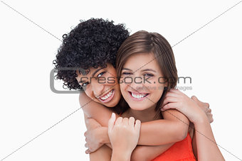 Teenager giving back hug to her friend