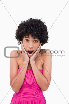 Young woman putting her hands on her cheeks in a sign of surpris