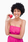 Smiling teenage girl holding a red apple in her right hand