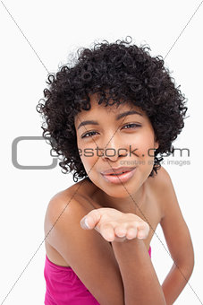 Smiling woman sending a kiss in front of the camera