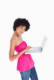 Young woman looking at the camera while using the touchpad of he
