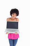 Smiling and beautiful teenager holding her laptop