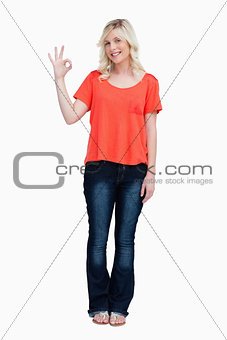 Smiling teenager looking at the camera while showing the OK sign
