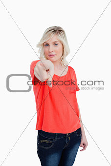 Young woman almost smiling while pointing her finger