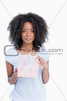 Young woman looking at the camera after opening her gift