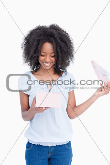 Smiling young woman looking at her birthday present