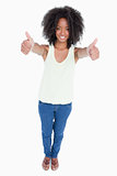 Young smiling woman placing her thumbs up in satisfaction