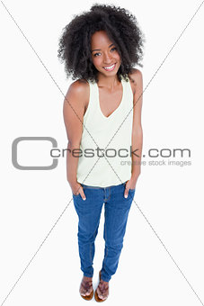 Smiling and relaxed woman putting her hands in pockets