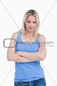 Blonde woman looking straight at the camera with arms crossed