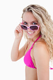 Smiling attractive teenager looking over her sunglasses