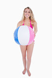 Pink and blue beach ball held by an attractive teenager