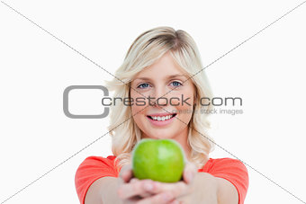 Smiling woman holding a delicious green apple