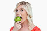 Attractive woman eating a delicious green apple 