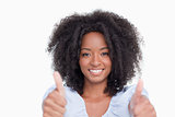 Young woman putting her two thumbs up in satisfaction