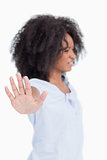 Side view of a woman being angry and making the hand stop sign