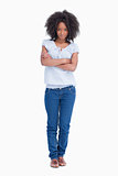Young serious woman crossing her arms while standing upright