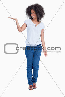 Young smiling woman putting her hand palm up