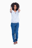 Young serious woman placing her two thumbs up in front of her