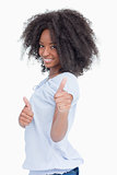 Side view of a smiling woman showing her thumbs up