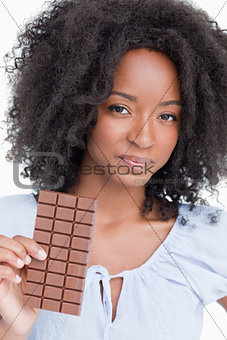 Young woman holding a delicious chocolate bar