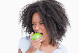 Young woman eating a green apple