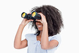 Young woman looking on the side through binoculars 
