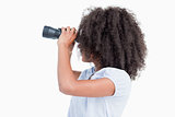 Side view of a young woman looking through binoculars