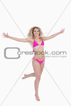 Smiling blonde woman opening her arms