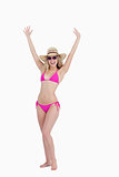 Young woman in a swimsuit raising her arms above the head
