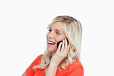 Woman laughing while talking on a cellphone