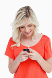 Smiling woman sending a text with her mobile phone